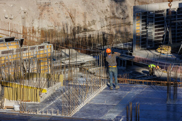 construction of a residential building or a shopping center. engineers and builders in helmets make...