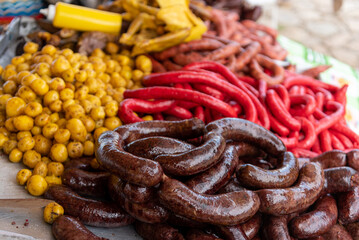 Sale of sausages of various types in a Colombian street agricultural market.