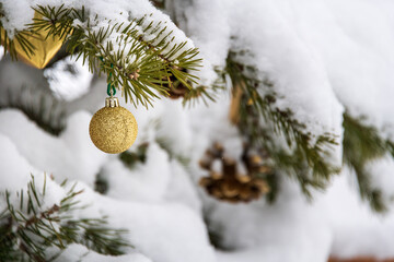 christmas decoration on the christmas tree covered with snow.