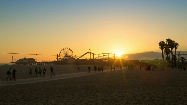 Lockdown Time Lapse Shot Of Tourists Beach With Amusement Park On Pier At Sunset - Santa Monica, California