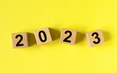 2023 new year on cubes on yellow background