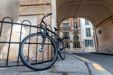 An old bicycle parked on a street in downtown Paris.