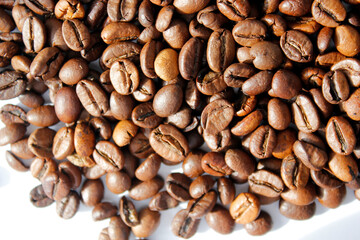 top view on coffee beans on white background, coffee beans texture on white, closeup of roasted coffee beans, roasted coffee beans background
