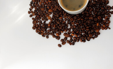 coffee in a cup with coffee beans background on white, top view