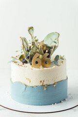 Anniversary luxury cake with white and blue cream cheese frosting decorated with transparent...
