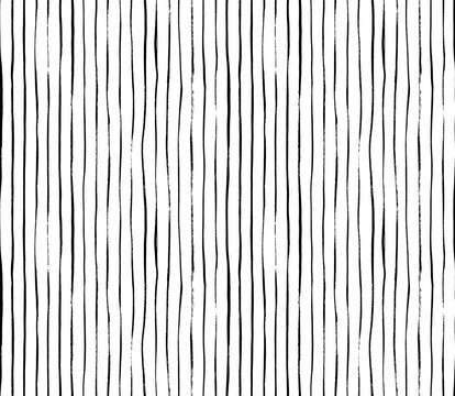 Brush drawn thin vertical lines seamless pattern. Decorative ornament with handdrawn lines. Grungy ink doodles with stripes. Black and white geometric pattern. Vertical parallel straight brush strokes