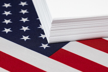 Ream of printer paper and United States of America flag. Paper products industry, trade and...