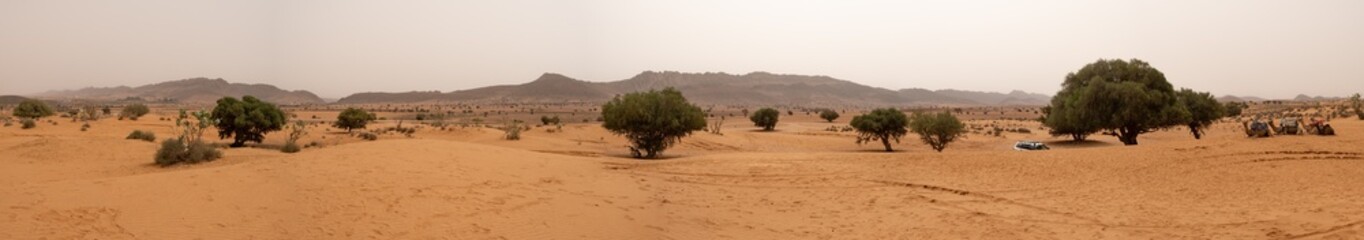  Amazing huge panorama landscape of lonely remote village surrounded by mountains, trees and sand...
