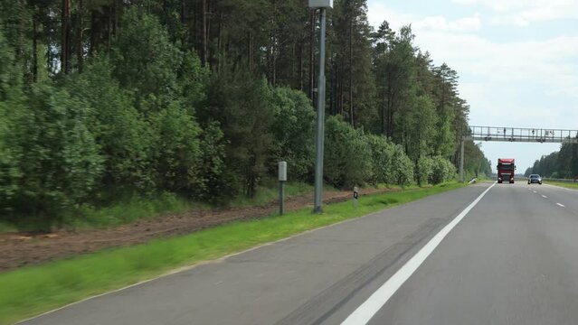 Road view on a summer day. Highways and cars, roadside and white road line markings.