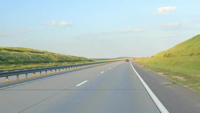 Road view on a summer day. Highways and cars, roadside and white road line markings.