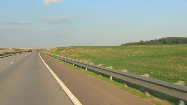 Road view on a summer day. Highways and cars, roadside and white road line markings.