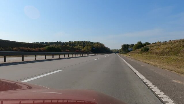 Road view on a summer day. Highways and cars, roadside and white road line markings.