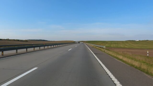 Road view on a summer day. Highways and cars, roadside and white road line markings.