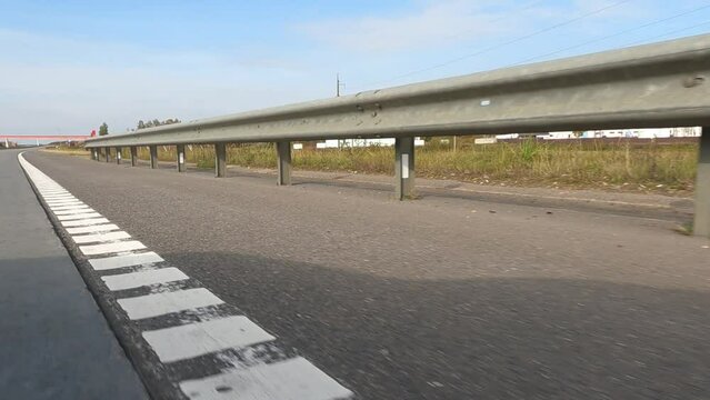 Road view on a summer day. Highways and cars, roadside and white road line markings.