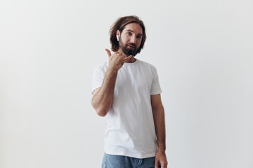 happy man listening to music and smiling in a white t-shirt on a white background happy