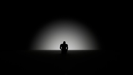 depressed silhouette of a man sitting in the dark