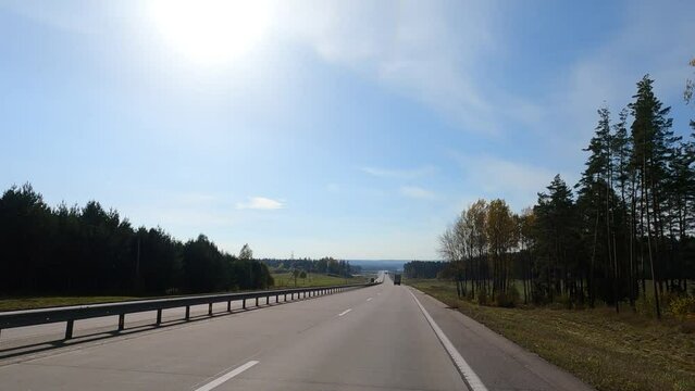 Road view on a summer day. Highways and cars, roadside and white road line markings.