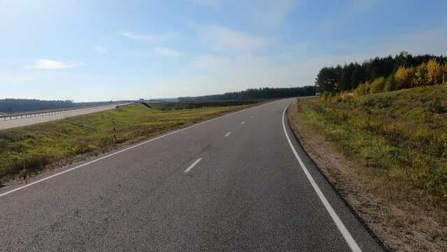 Road view on a summer day. Highways and cars, roadside and white road line markings.