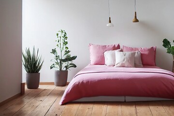 Cozy, feminine bedroom with pink bed, decorative cushions and plant on a wooden stool standing against white, empty wall. Real photo with a place for your furniture.