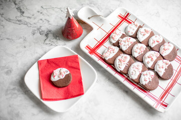 Chocolate Cookies Dipped in White Icing and Sprinkled with Peppermint