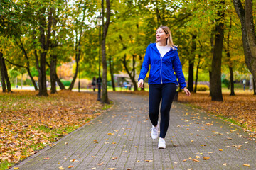 Beautiful woman walking in city park
