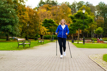 Nordic walking - woman training in city park
