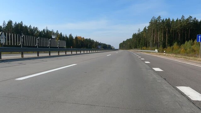Road view on a summer day. Highways and cars, roadside and white road line markings.