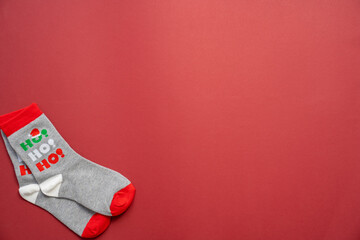 christmas and new year's socks on a red background, festive season, holiday clothes ho ho ho, copy...