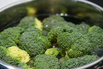 Fresh green broccoli cooked boiled in a pan. Close-up.