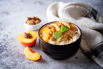 Sweet caramel rice porridge with caramelized peaches and walnuts in a bowl