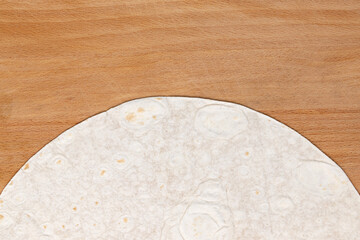 pita bread isolated on wooden background, top view