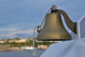 Brass bell hand activated. Signal small bell. Communication tool to create a sound. Bell on a boat