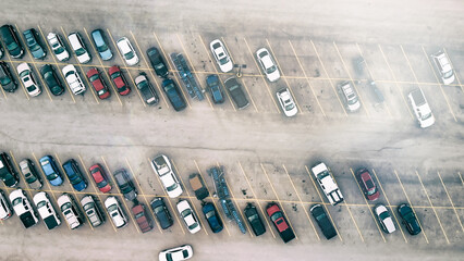 Aerial view of cars at large outdoor parking lots, USA. Outlet mall parking congestion and crowded...