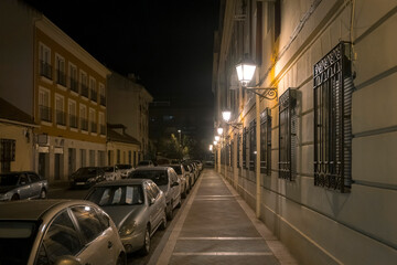 Fototapeta na wymiar Illuminated Street Lights In City At Night