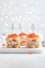 Christmas tree canape with Smoked Salmon, Cream Cheese, Dill, Horseradish Pate and red caviar for festive xmas snack - obrazy, fototapety, plakaty