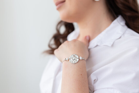 Close-up of woman wearing pearl and silver bracelet. Jewelry, bijouterie and accessories concept
