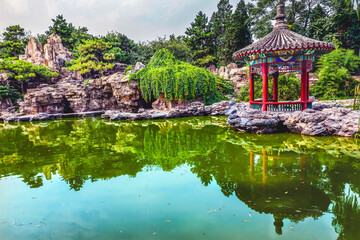 Fototapeta na wymiar Red Pavilion Garden Pond Temple of Sun BeijingVChina