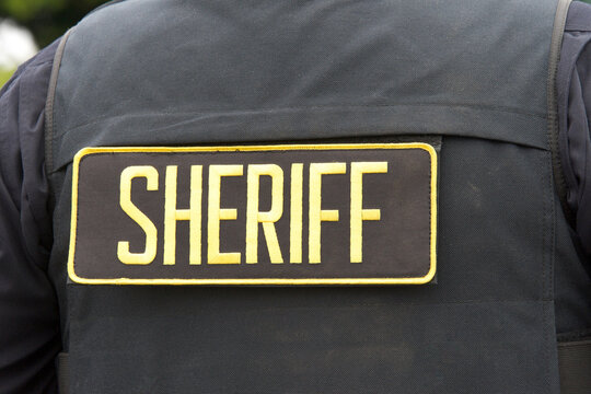 Close up on Sheriff letters on back of flack jacket.