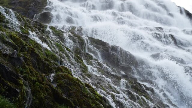 Clear stream running through stone boulders, Mountain river, Huge Icelandic waterfall in 4k slow motion