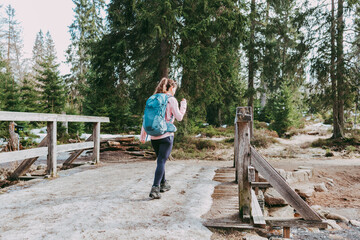 The girl is engaged in walking, hiking in the spring forest. Fitness and outdoor activities. Healthy lifestyle