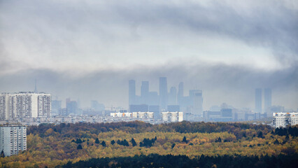 Smoke from a fire over the roofs of city buildings, top view