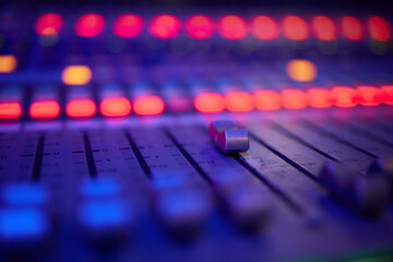 View of music mixer in concert, filled with lights.