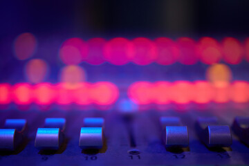 View of music mixer in concert, filled with lights.