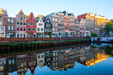 Fototapeta premium Amsterdam Netherlands - colorful buildings reflected in a canal