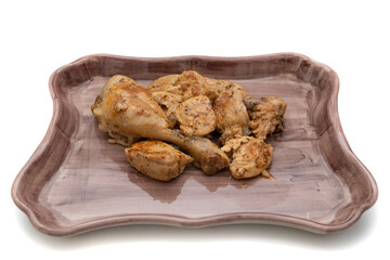 A porcelain tray with garlic chicken, on a white background. Spanish food concept.