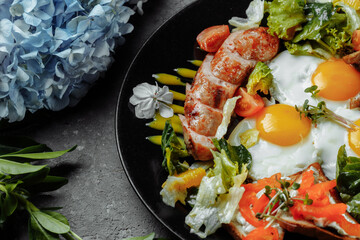Full English breakfast with toast bread, chicken egg, mustard sauce, champignons, salad mix, cheese cream, sweet pepper
