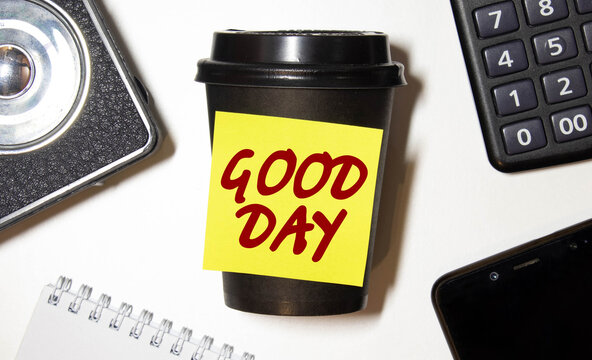 Good day Inscription good day in a cup of coffee and wooden background