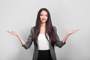 Surprised businesswoman hows your product with her hand.