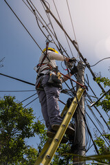 unrecognizable person installer of aerial technology cable and internet with security
