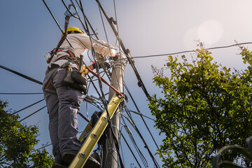 unrecognizable person installer of aerial technology cable and internet with security